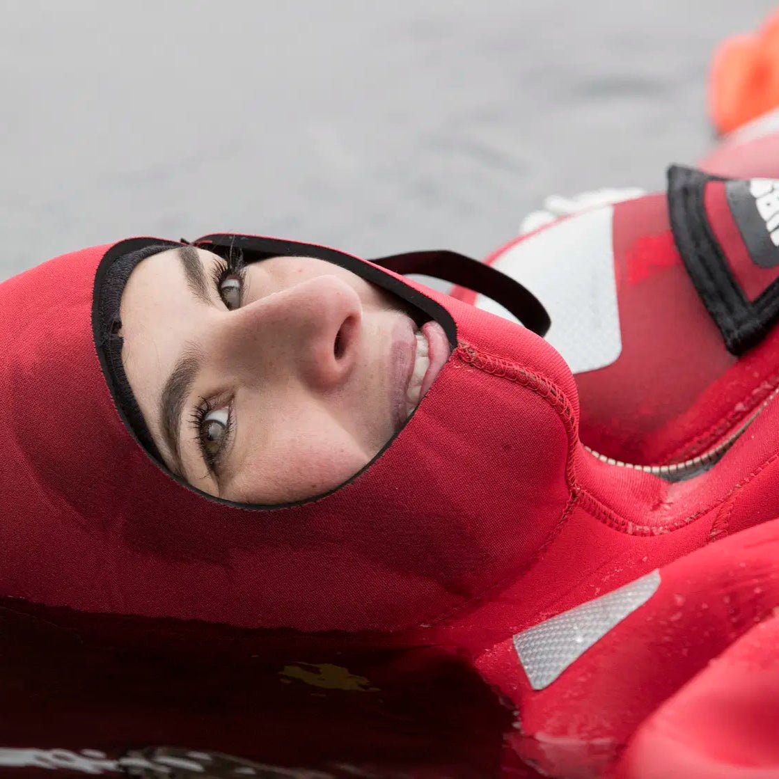 Close-up of a person floating in water wearing a red rescue suit, Arctic floating in the wilderness by Safartica