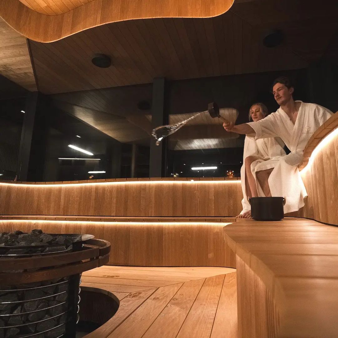 Couple enjoying the Wave sauna during the Arctic spa experience with bathrobe dinner at Invisible forest lodge