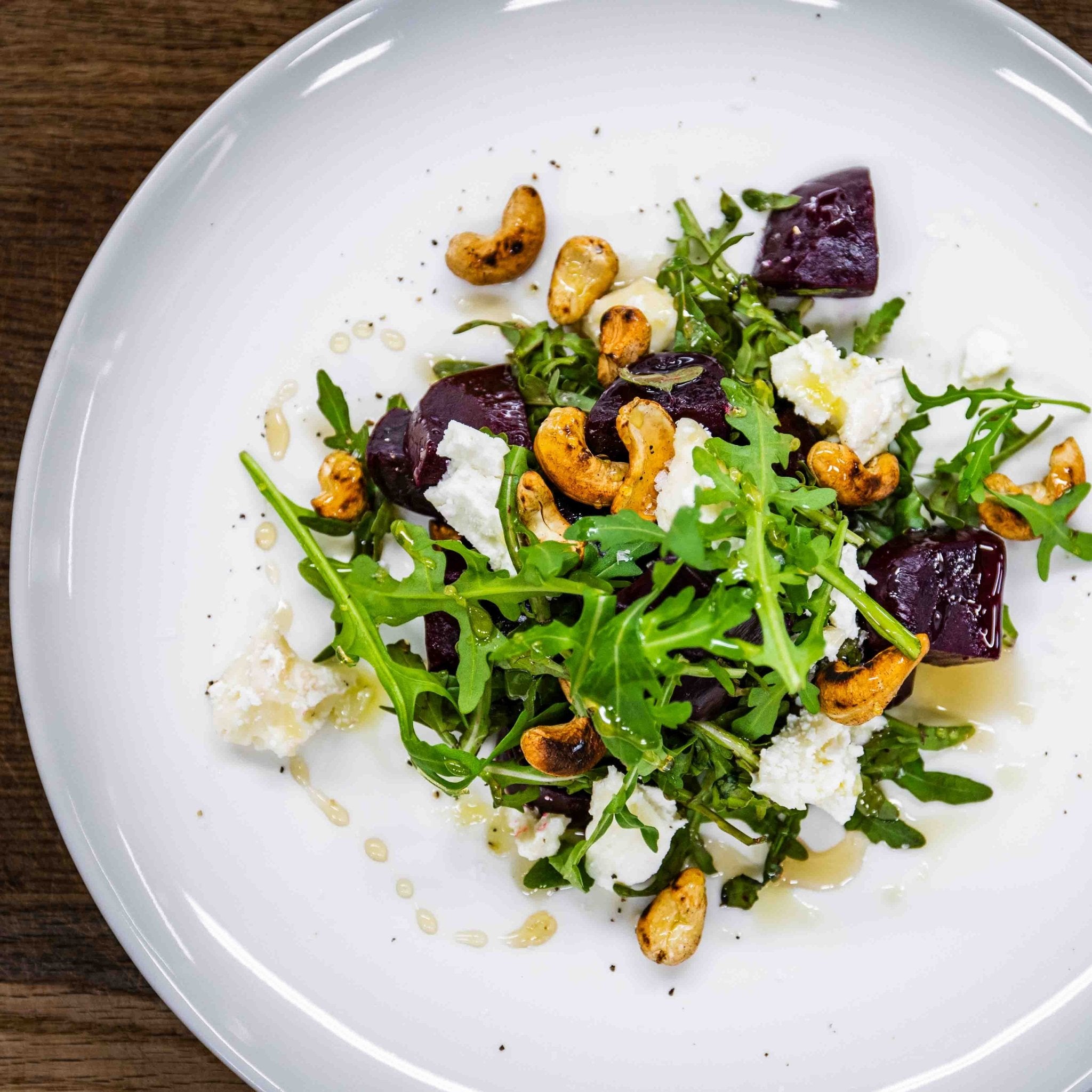 Christmas House Restaurant salad with arugula, roasted cashews, beets, and cheese served by Santa Claus Holiday Village