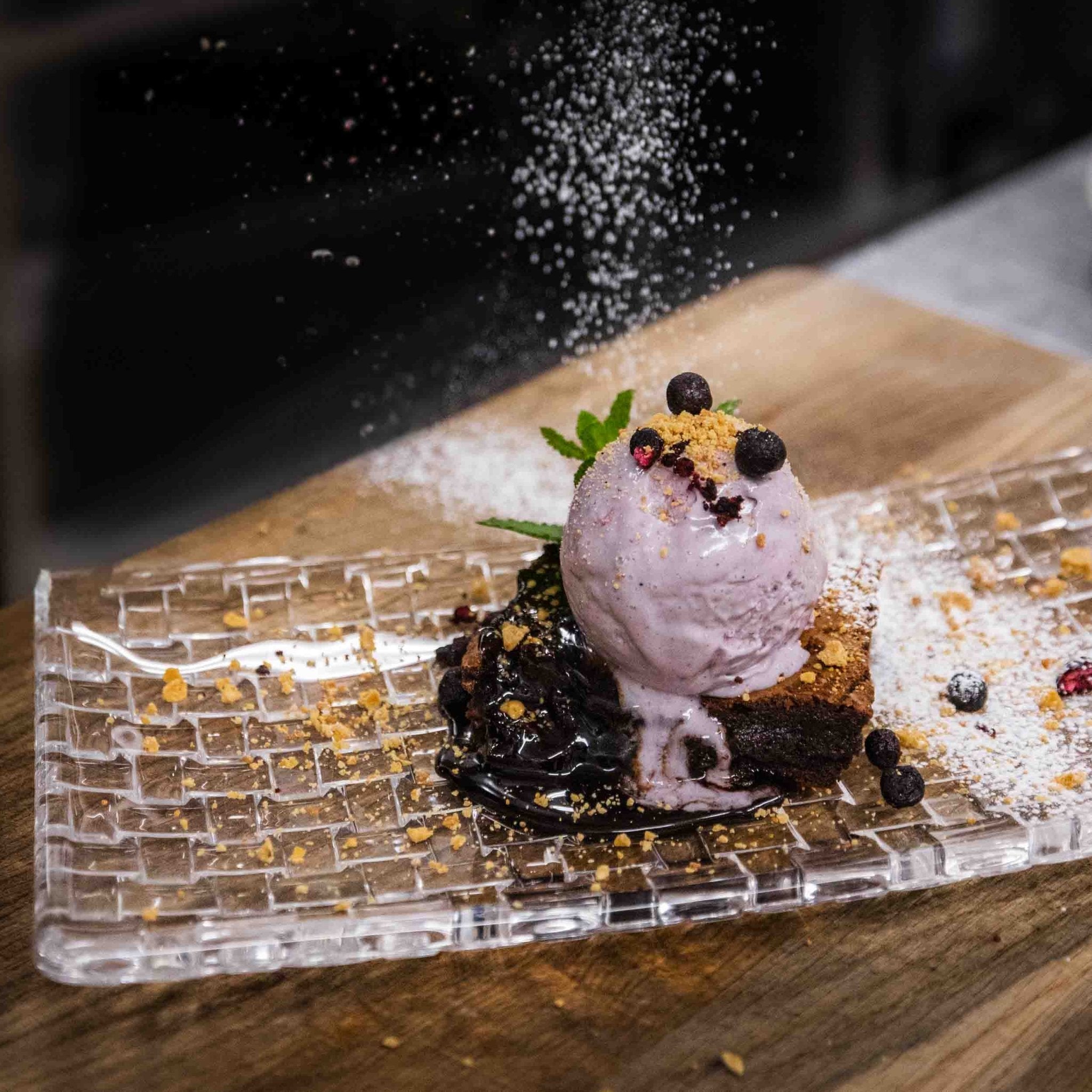 Dessert with blueberry ice cream and chocolate sauce at Christmas House Restaurant by Santa Claus Holiday Village