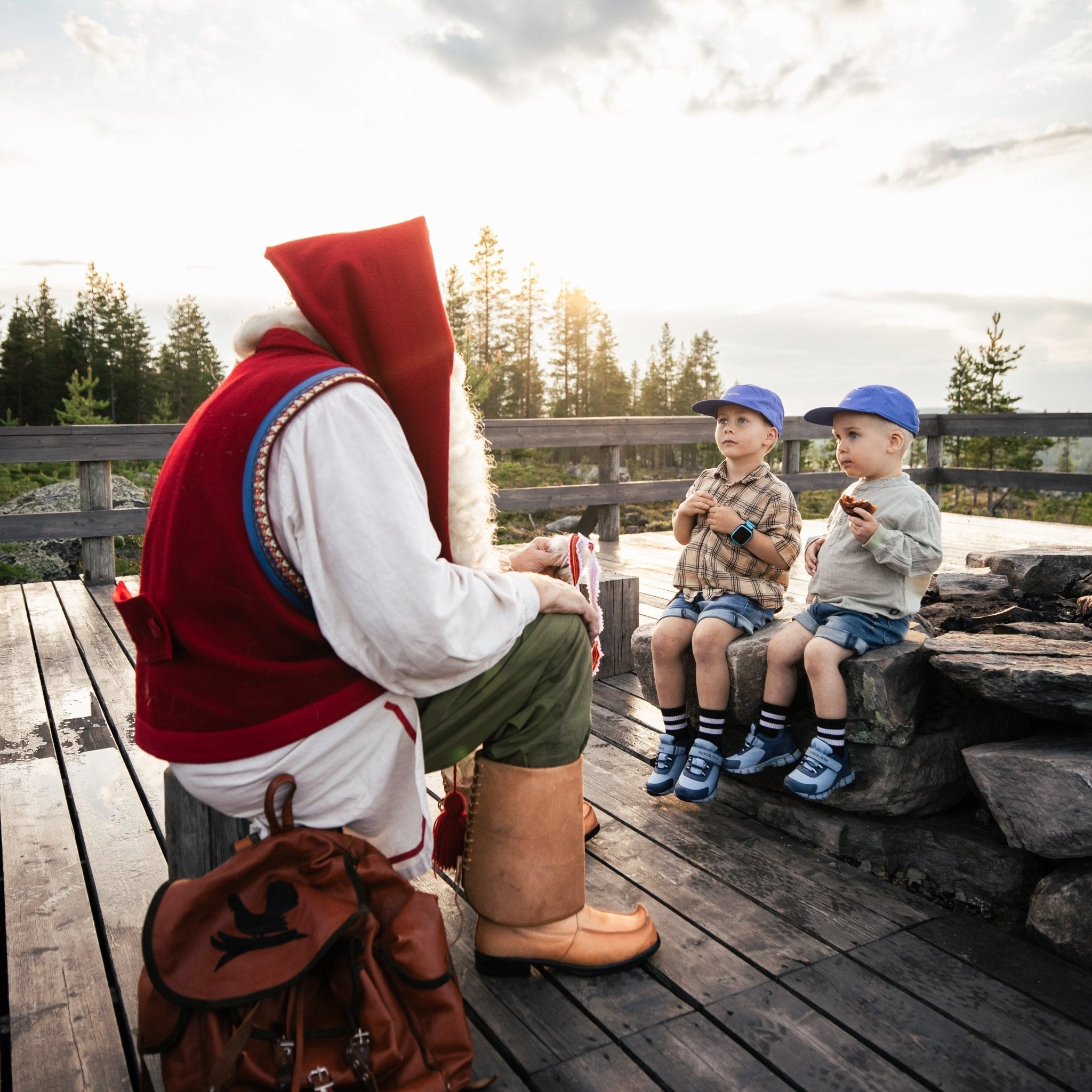 Meeting with Santa Claus with children outdoors in nature near Rovaniemi, peaceful moment by Porovaara vendor.