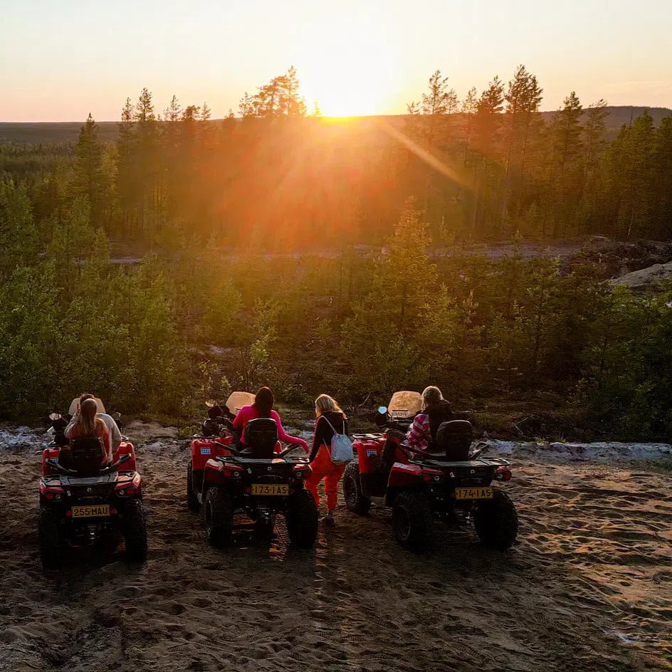 Sunset view with people on quad bikes in Lapland forest for Midnight Adventure with Quad Bikes by Pure Lapland
