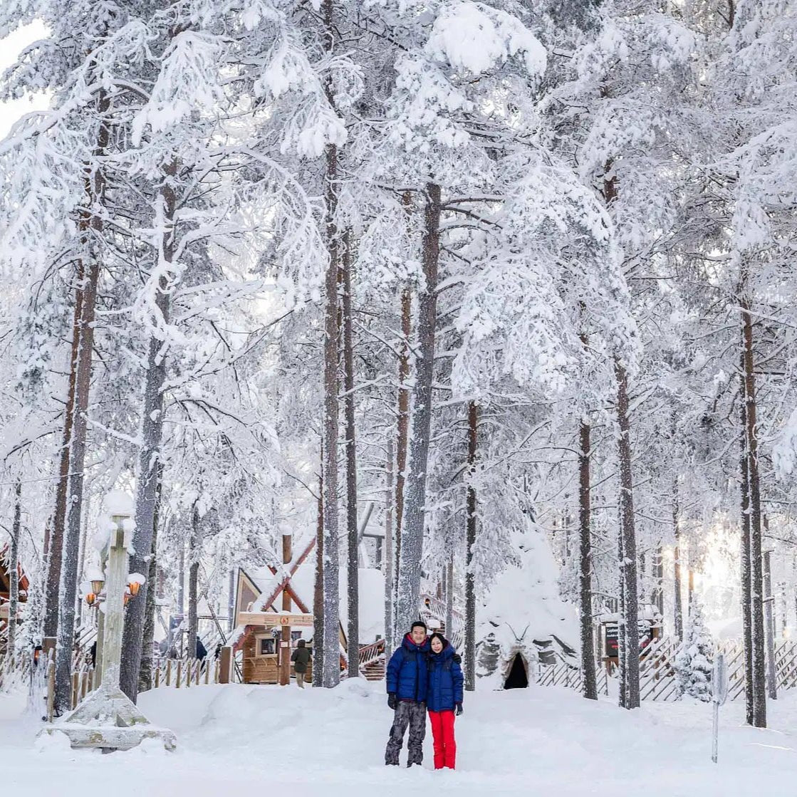 Photoshoot in Santa Claus Village with snowy trees and visitors enjoying a magical winter setting Beyond Arctic
