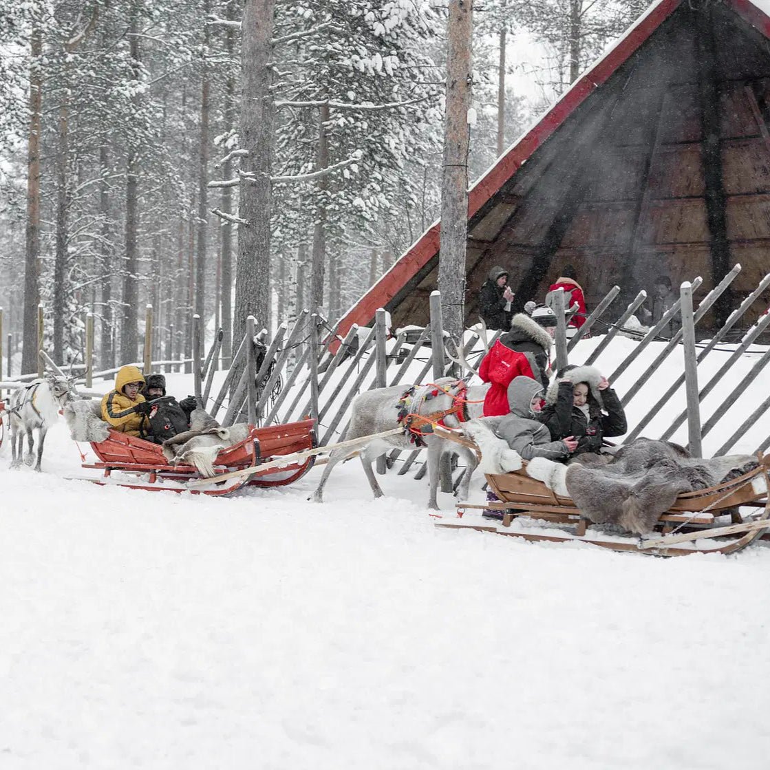 Visitors enjoy reindeer sleigh rides in the snowy Santa Claus Village during Photoshoot in Santa Claus Village by Beyond Arctic