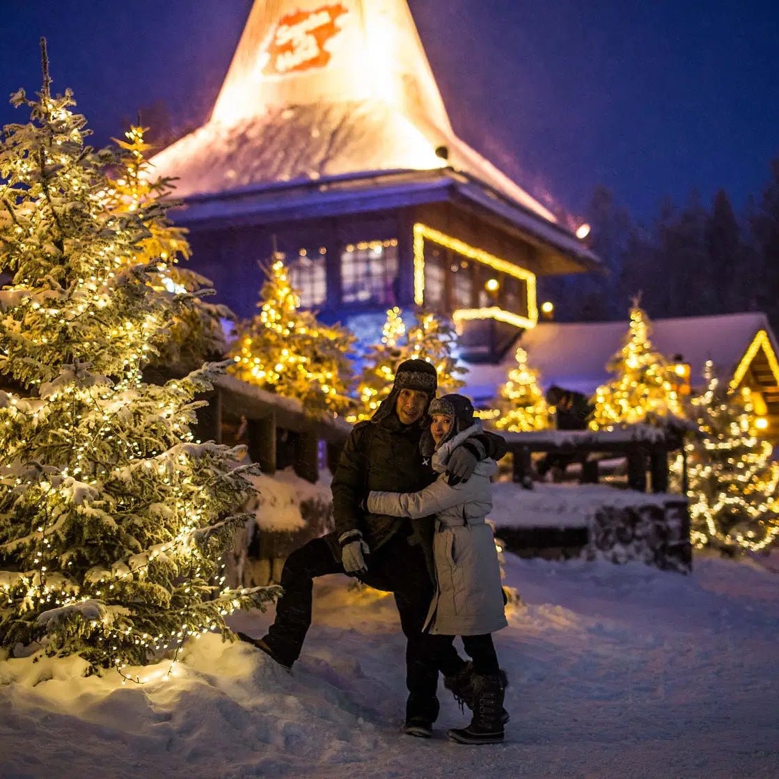 Couple posing among Christmas trees at Santa Claus Village during photoshoot by Beyond Arctic, Photoshoot in Santa Claus Village
