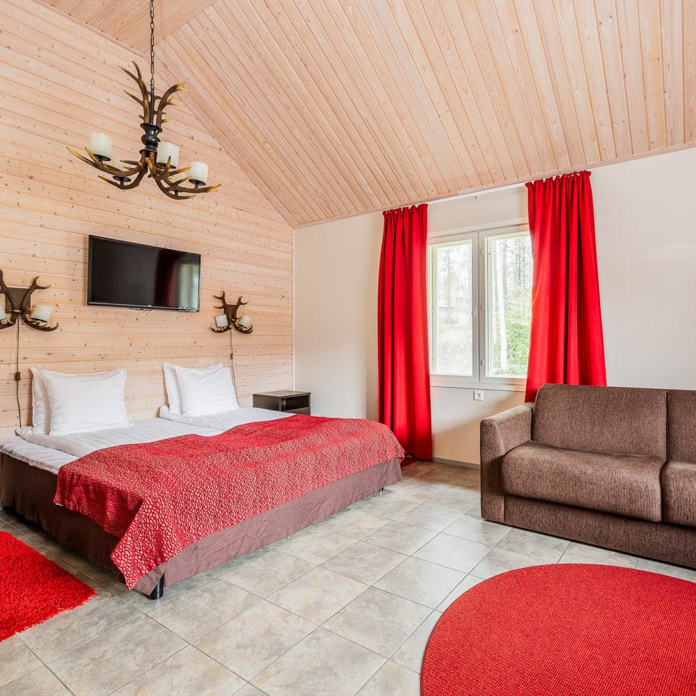 Cozy bedroom with red accents and modern amenities in Santa Claus Holiday Village Santa Claus Holiday Village