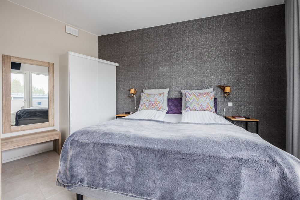 Cozy modern bedroom with twin beds and soft blankets in Santa Claus Holiday Village Santa Claus Holiday Village