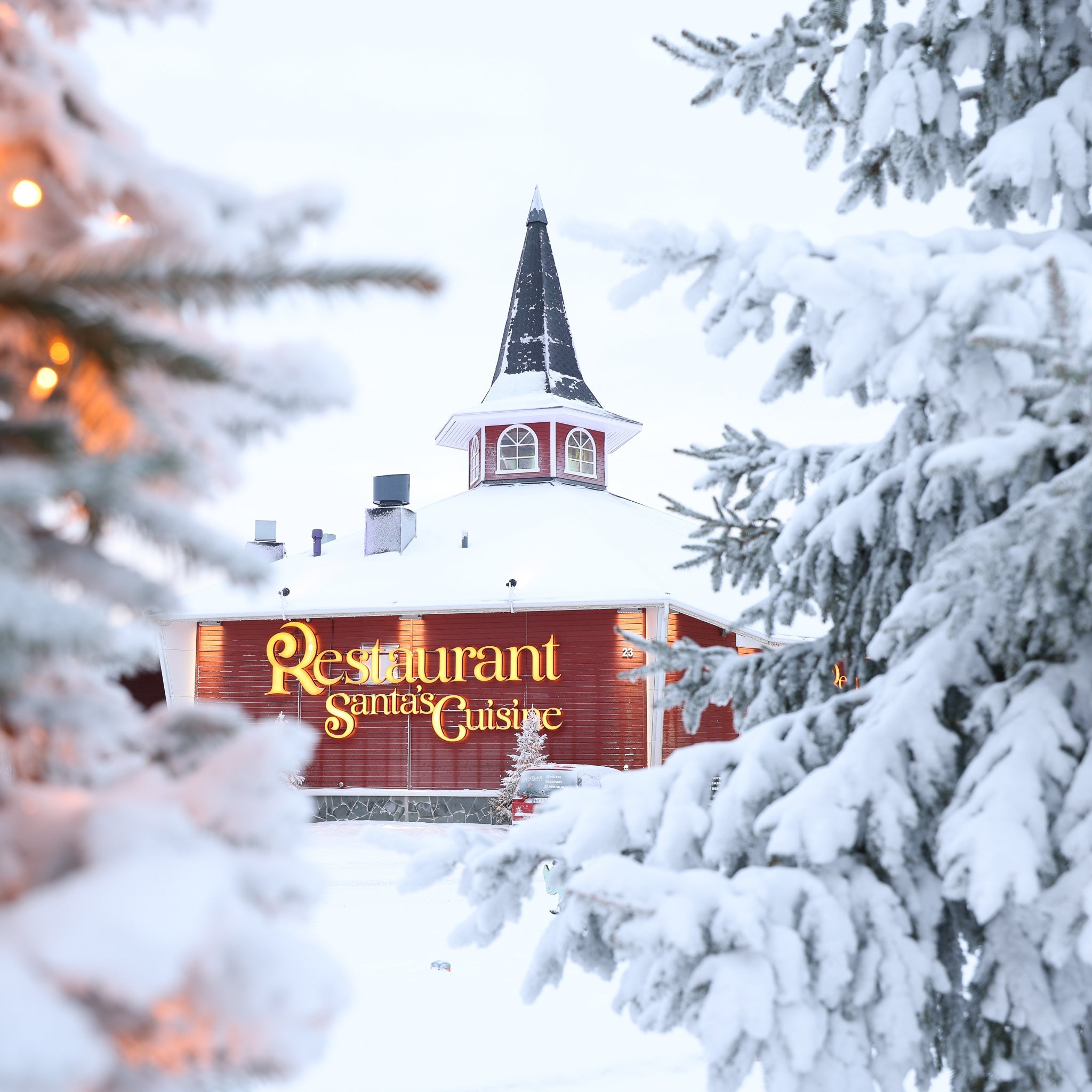 Snow-covered Santa's Cuisine Restaurant exterior in winter season at Santa Claus Holiday Village.