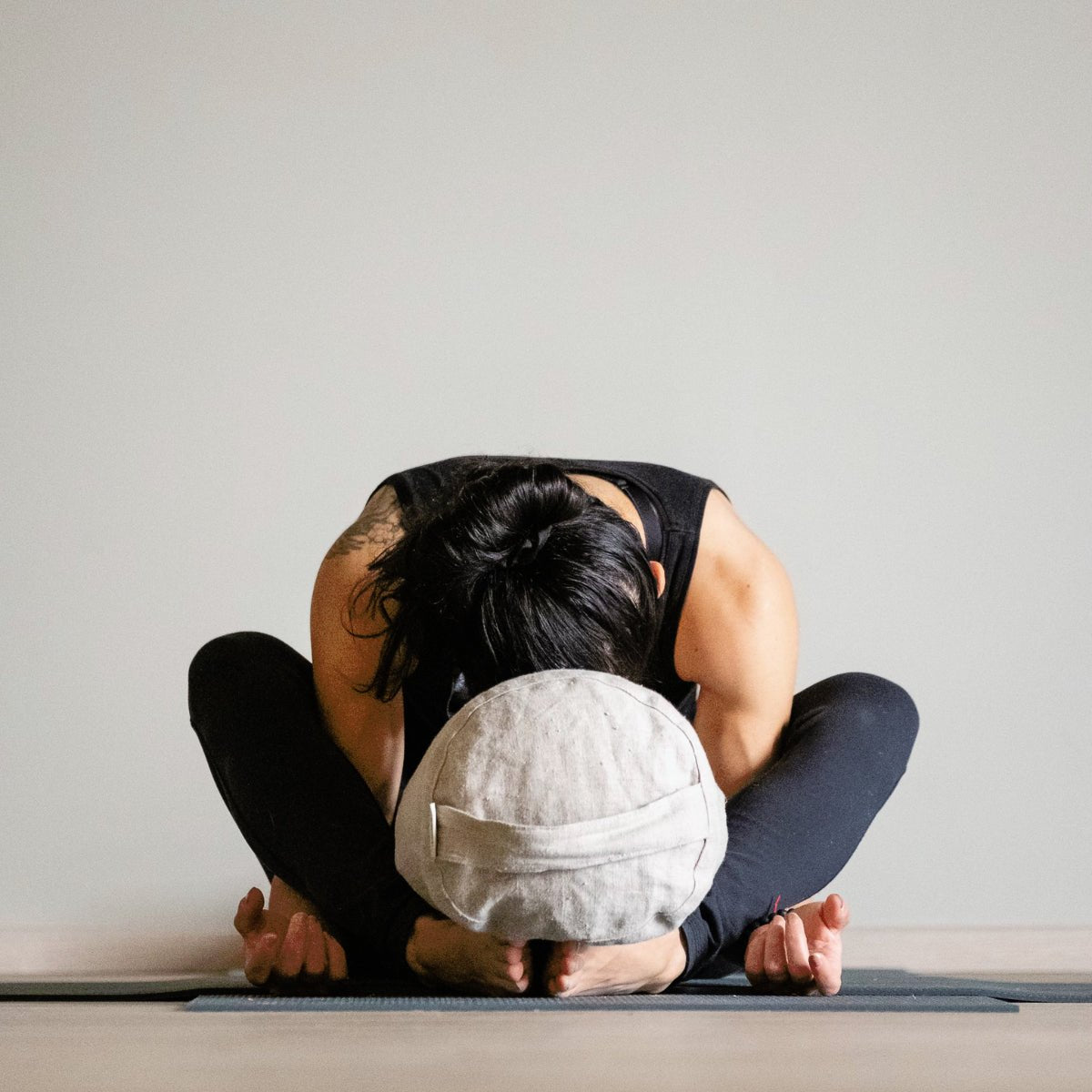 Person in a seated forward bend yoga pose in a calm studio for Yogaclass by Lapin Väki