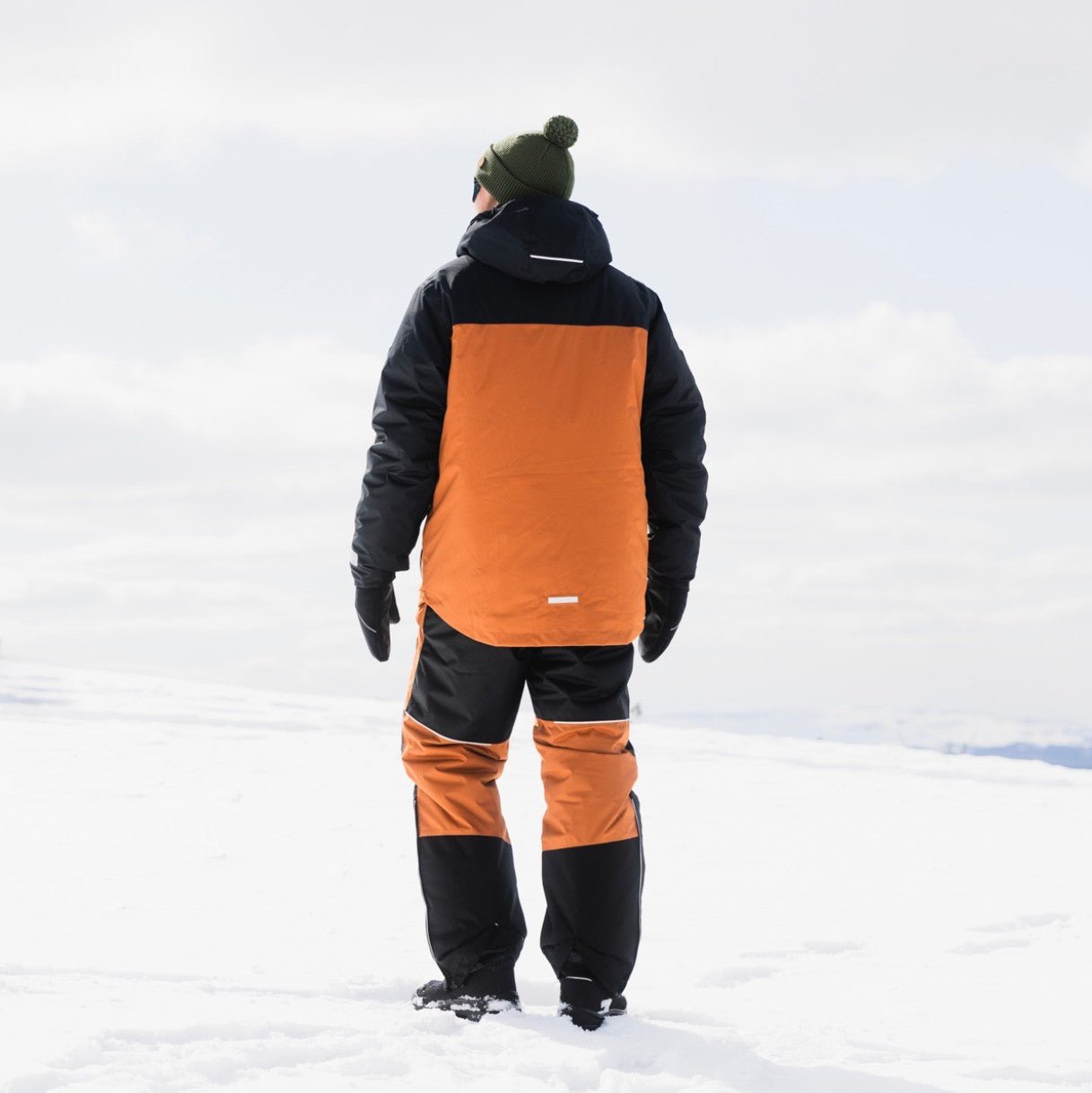 Back view of person wearing Winter Clothing Set Rovaniemi in snowy landscape by WinterRent