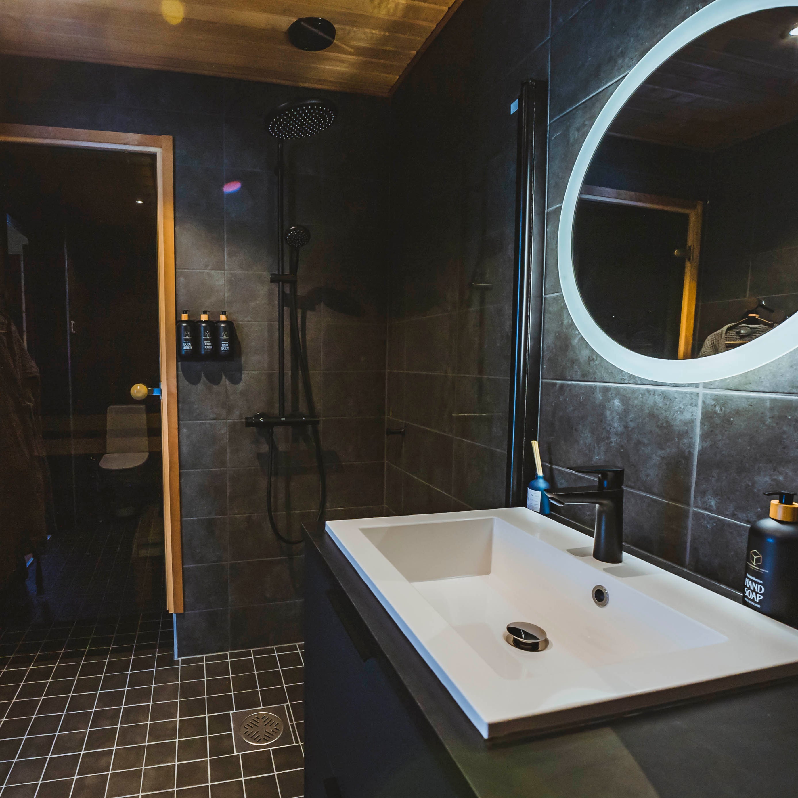 Modern stylish bathroom with shower and illuminated mirror in the Most unique sleeping experience in Lapland by Your City Guide