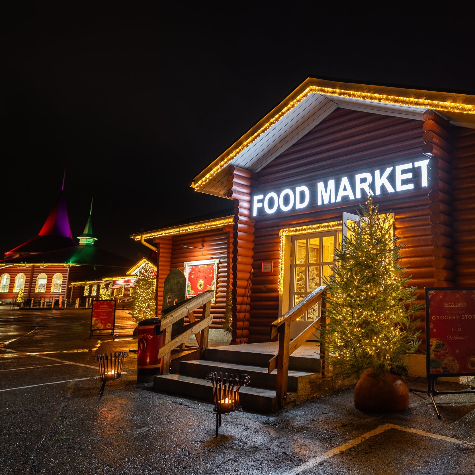 Wooden food market building at night with Christmas decorations