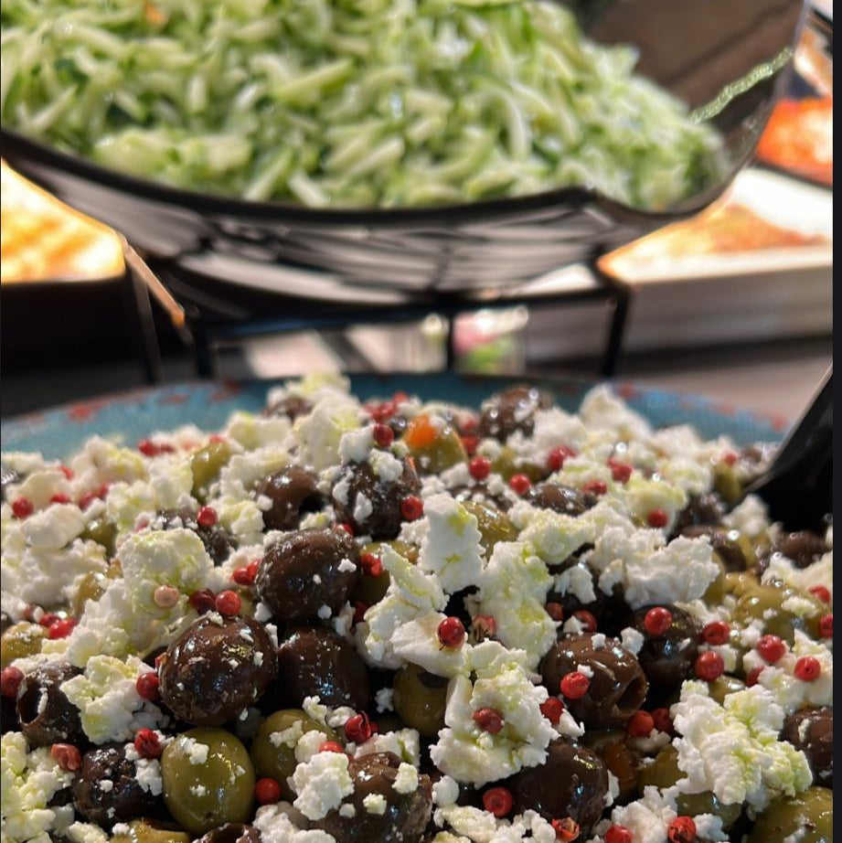 Close-up of olive and feta cheese salad with red peppercorns at Feenix Restaurant Rinteenkulma by Ravintola Feenix