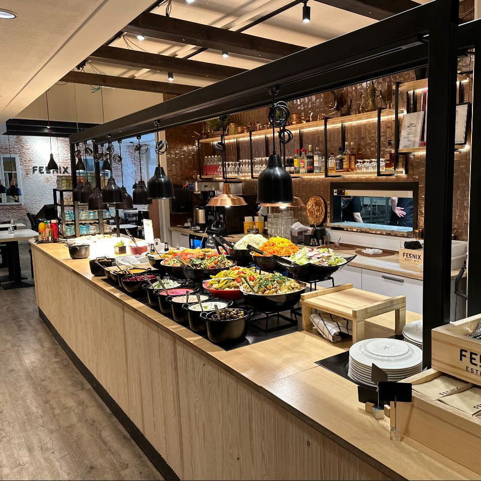 Modern lunch buffet with fresh salads and grilled dishes at Feenix Restaurant Minimani by Ravintola Feenix