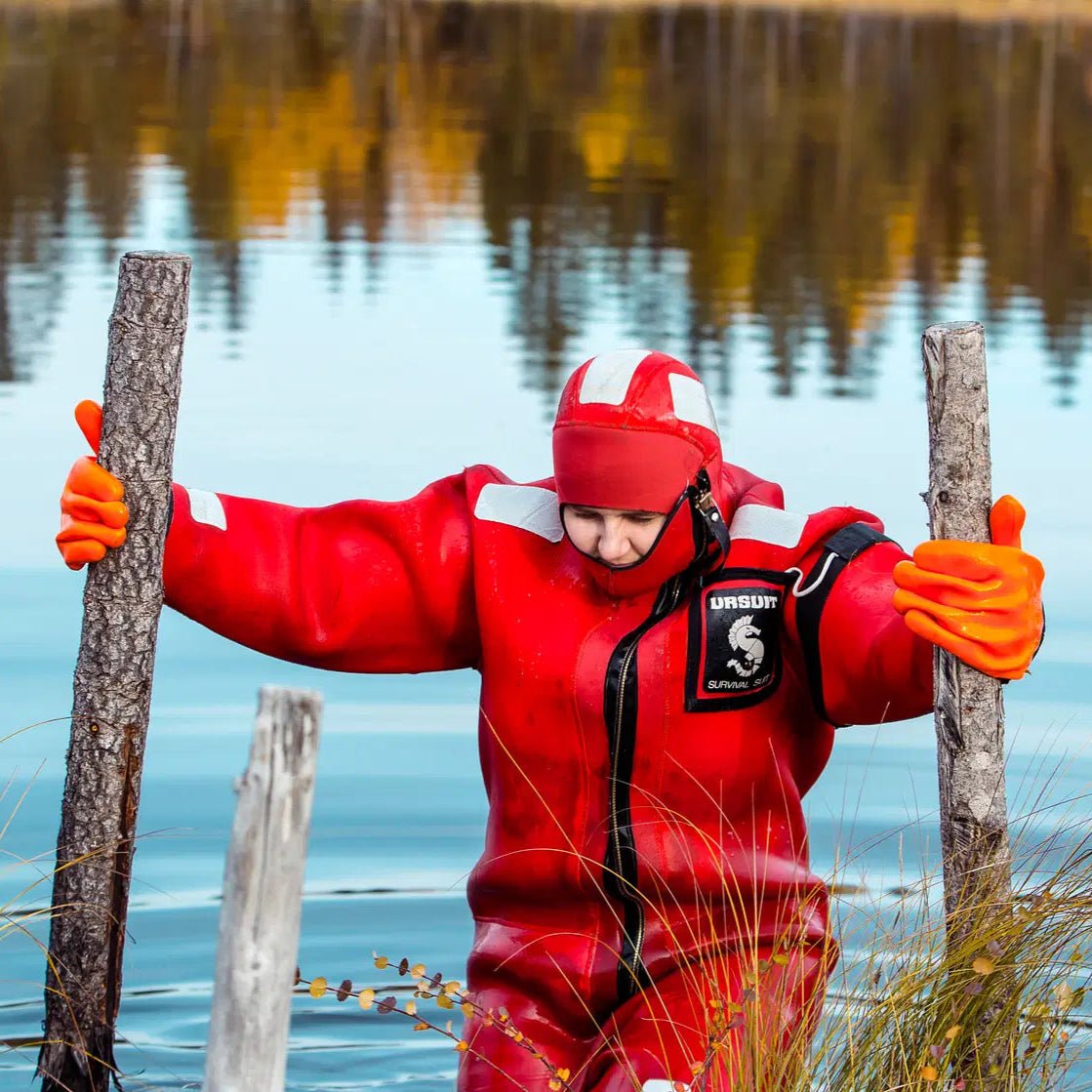 Person wearing a red rescue suit floating in icy water in wilderness for Arctic floating in the wilderness Safartica
