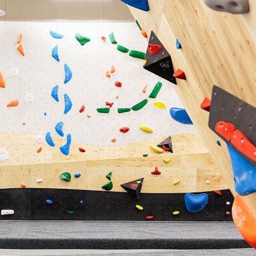 Indoor climbing wall with colorful holds for the Guided Climbing Experience by Lapin Väki