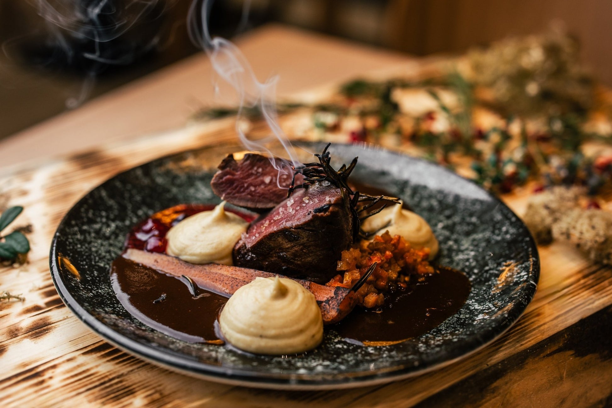 Gourmet dish with smoked meat, mashed potatoes, and sauce at Lapland Winter Park - Snow experiences vendor