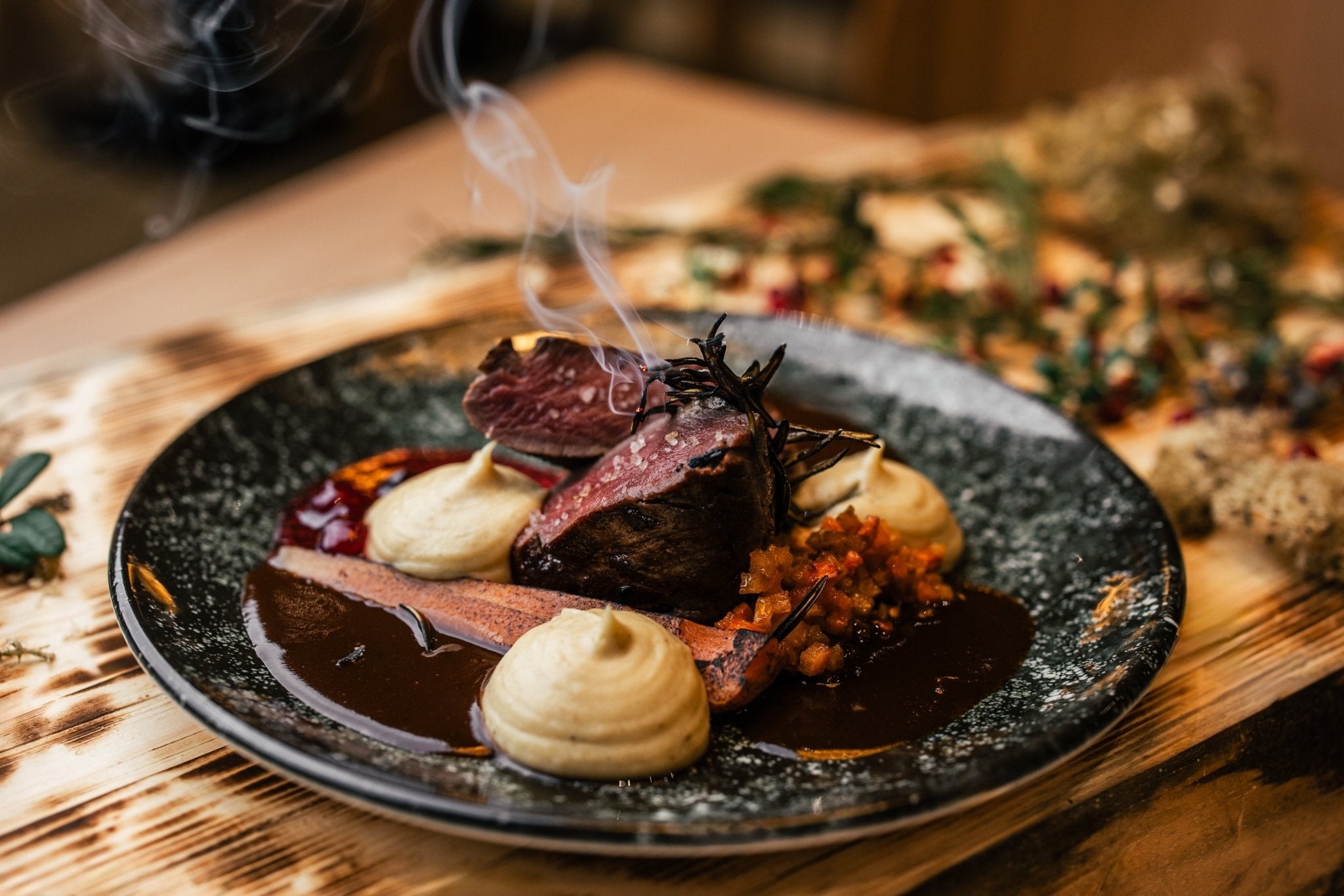 Gourmet dish with smoked meat, mashed potatoes, and sauce at Lapland Winter Park - Snow experiences vendor
