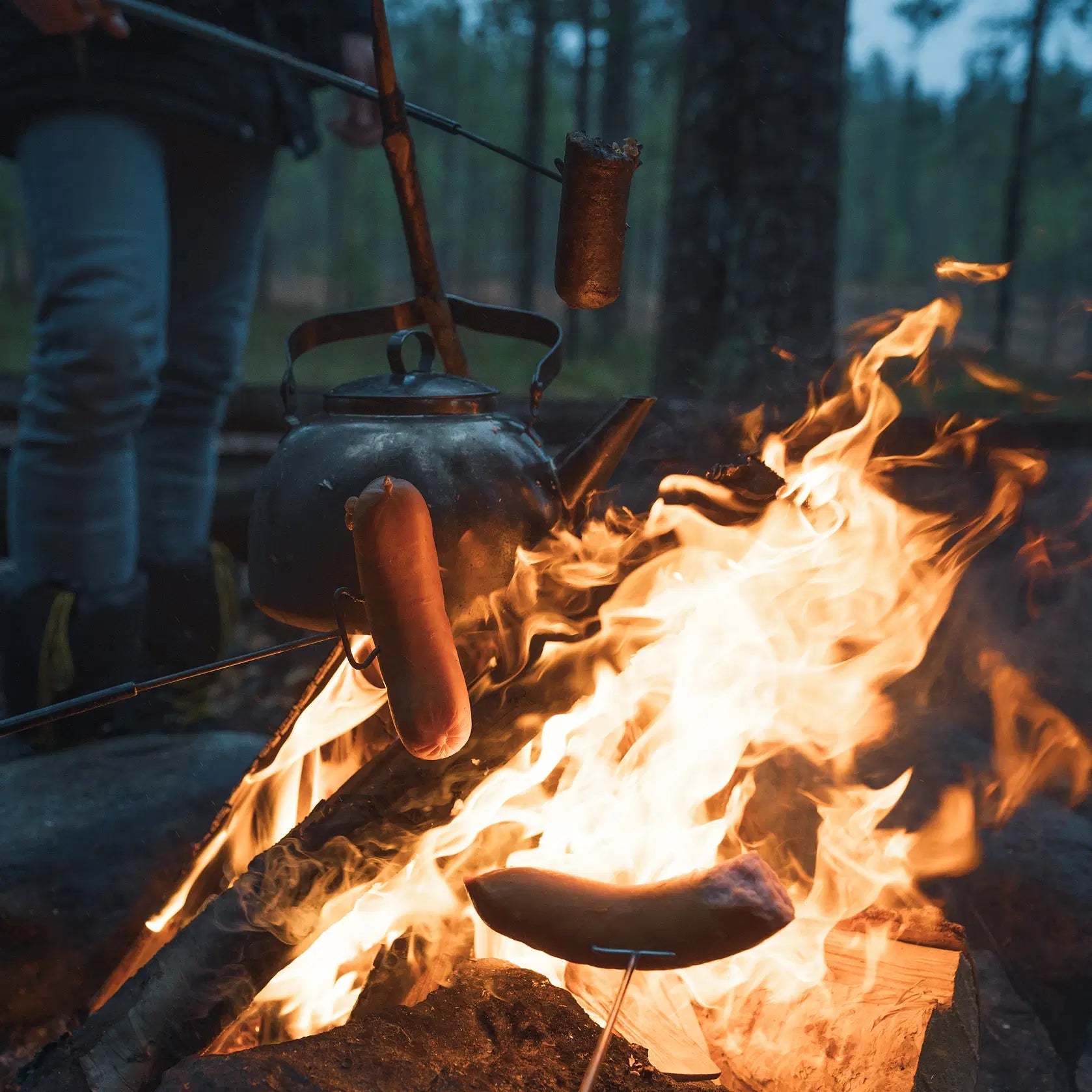 Campfire cooking and fire-making skills during the Magical Forest Hiking Adventure in Finnish forest by Pure Lapland