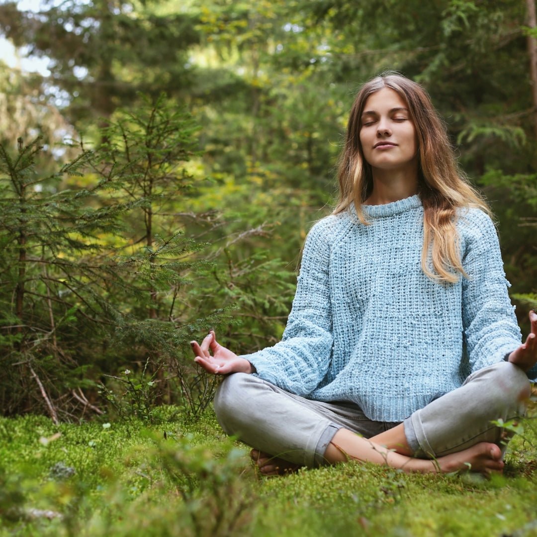Woman meditating in forest practicing Nature Yoga & Mindfulness by Lapin Väki.
