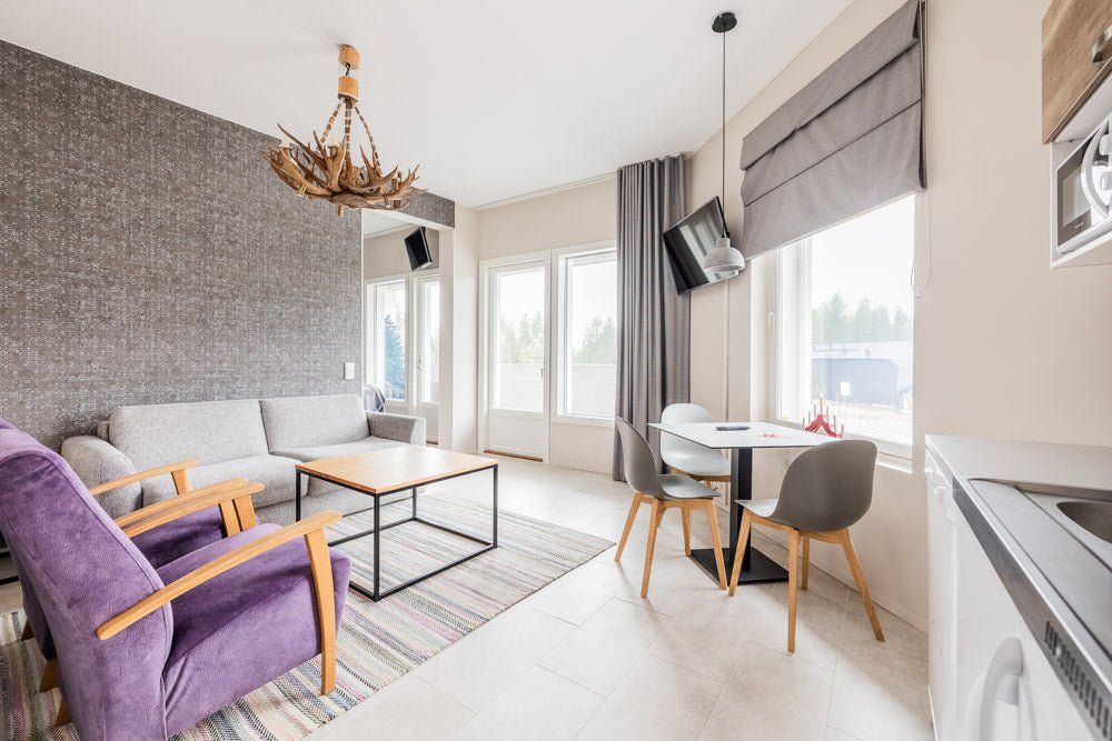 Bright living room with modern furnishings and dining area in Santa Claus Holiday Village Santa Claus Holiday Village