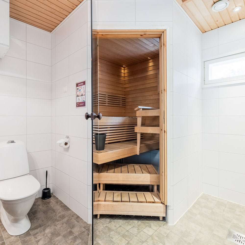 Bathroom with toilet and wooden sauna in Santa Claus Holiday Village apartment Santa Claus Holiday Village