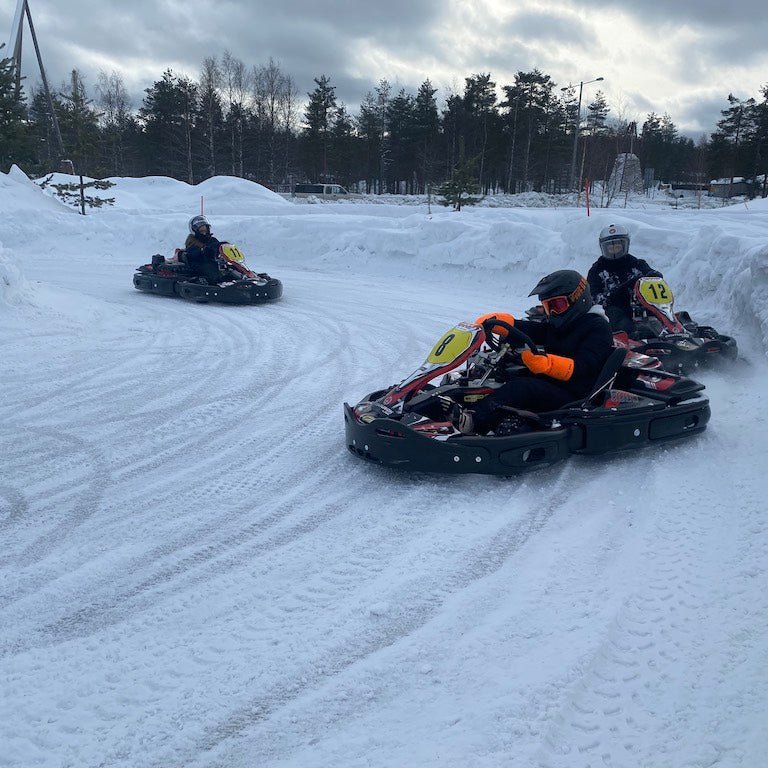 Santa´s Ice Karting start 12.00 on a snowy track with racers in winter gear at Santa's motor park